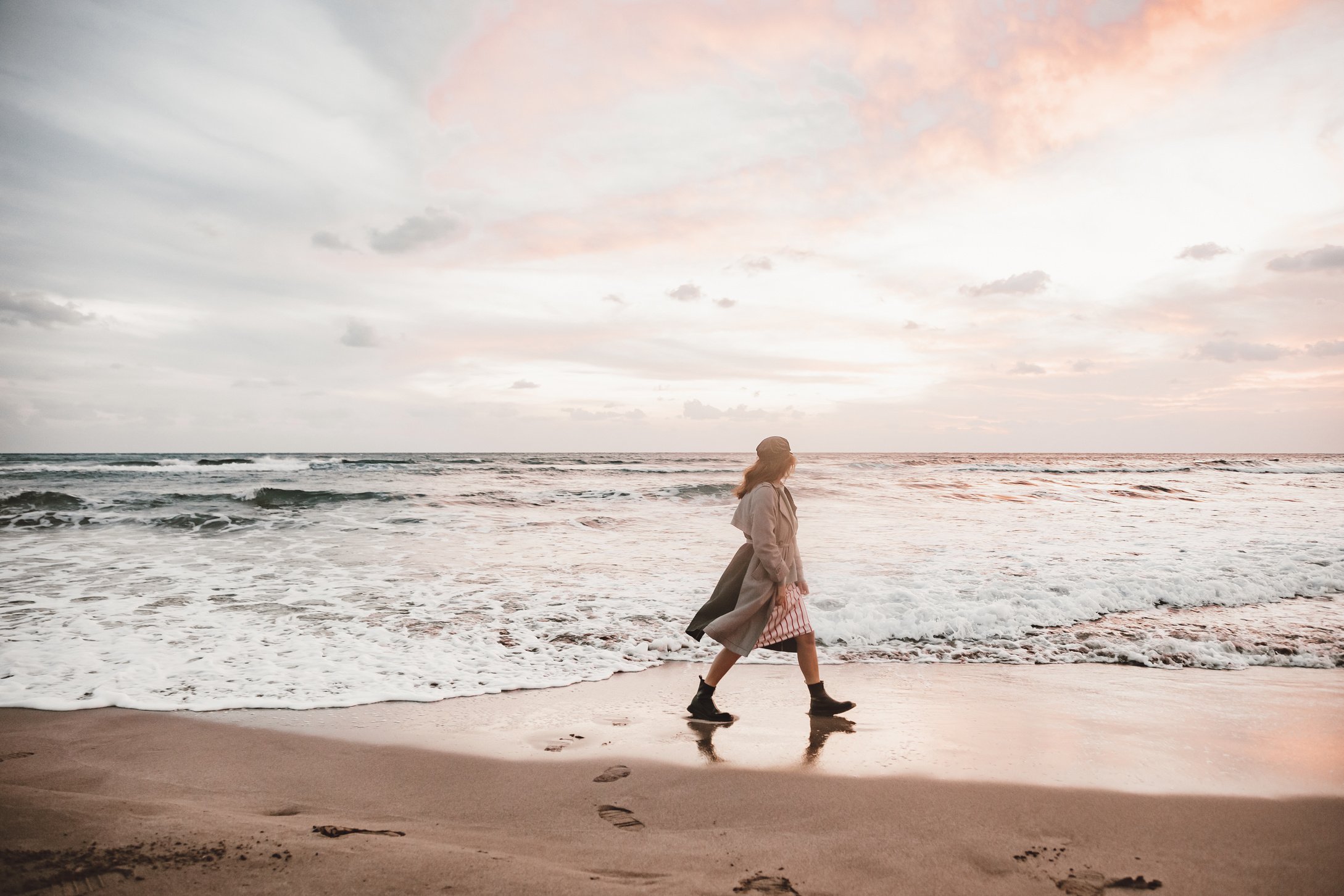 A Woman Walking on a Beach